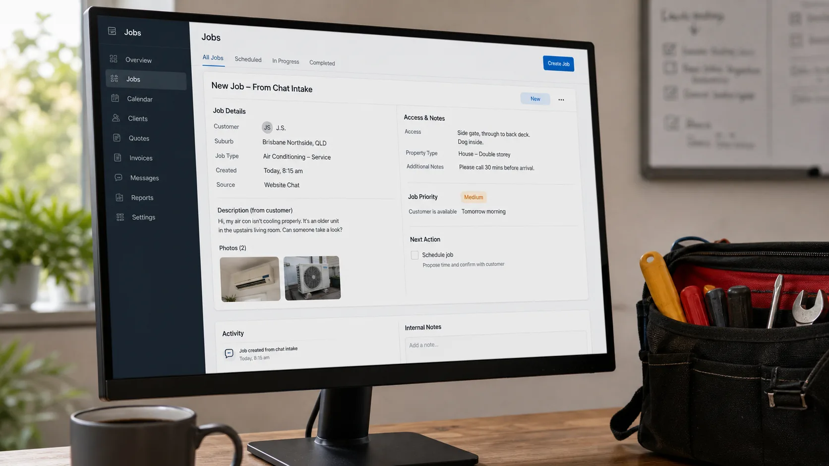 A desktop monitor showing a job-management dashboard with a job card populated from a chat brief.